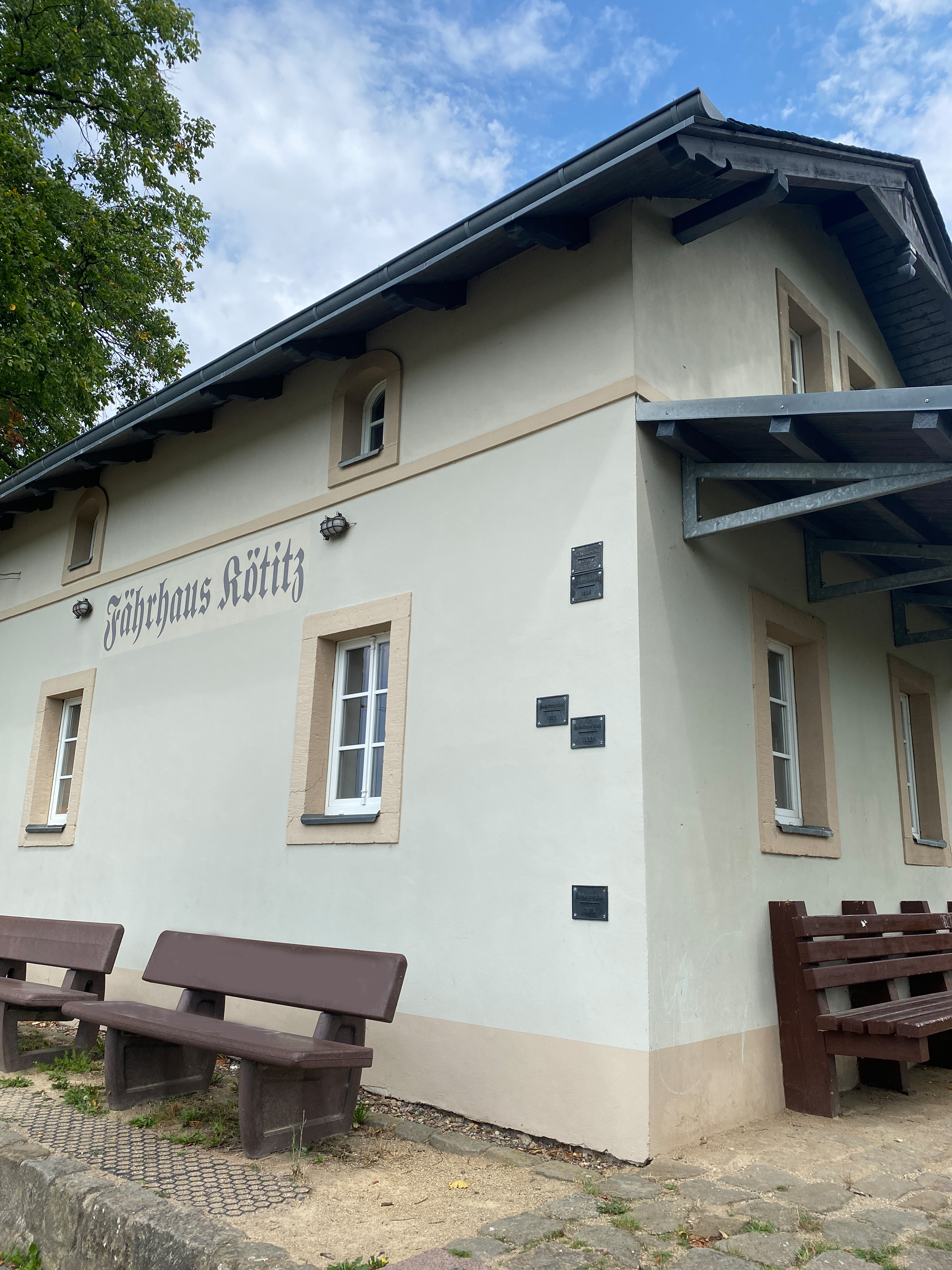 Haus mit Bänken davor.